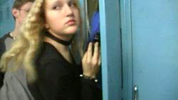 shot of Vanessa pulling a gun out of her locker 